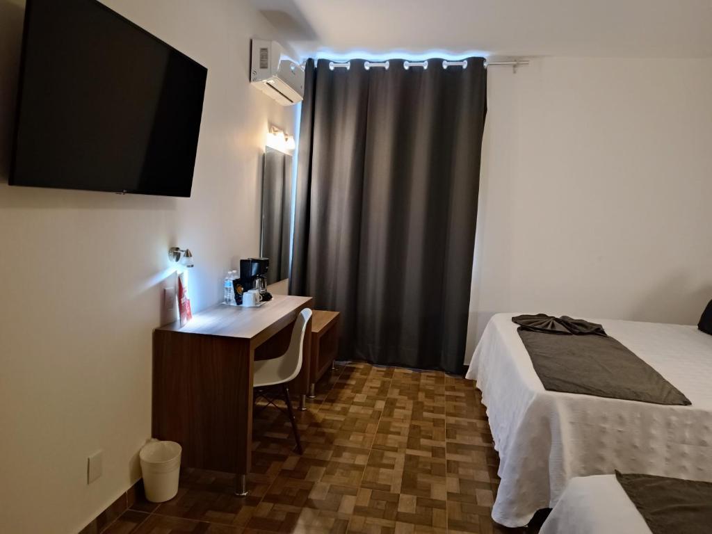 Postel nebo postele na pokoji v ubytování Hotel Las Pergolas