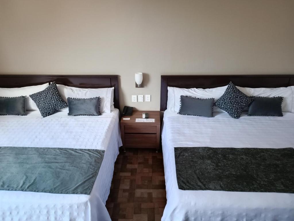 Postel nebo postele na pokoji v ubytování Hotel Las Pergolas