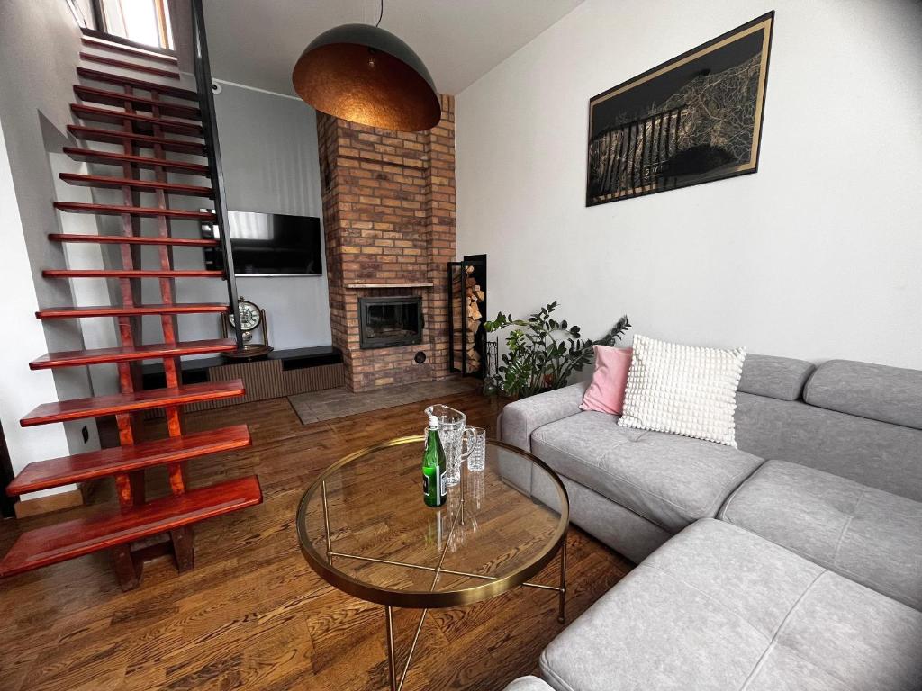a living room with a couch and a glass table at Apartament Kapitański in Gdynia
