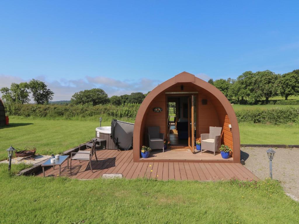 a gazebo with a table and chairs in a field at Ty Twt Teifi in Tregaron