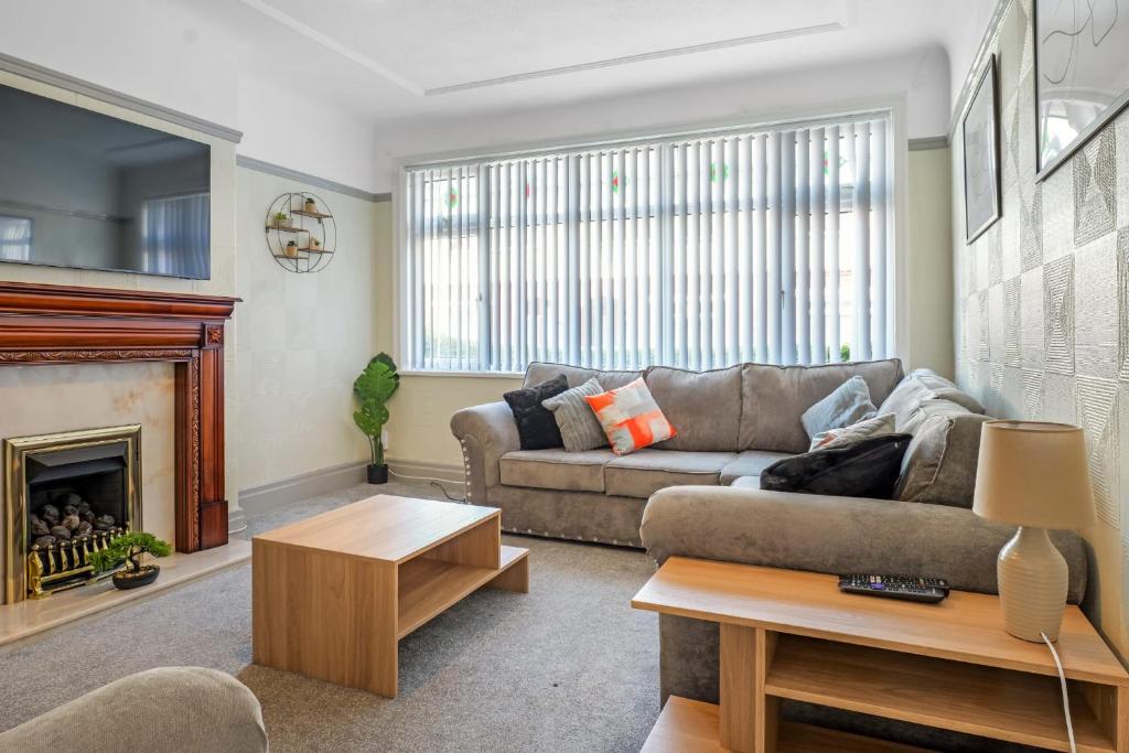 a living room with a couch and a fireplace at Contractor Stays, Newly Renovated, Free Parking, Sleep 7 in Wallasey