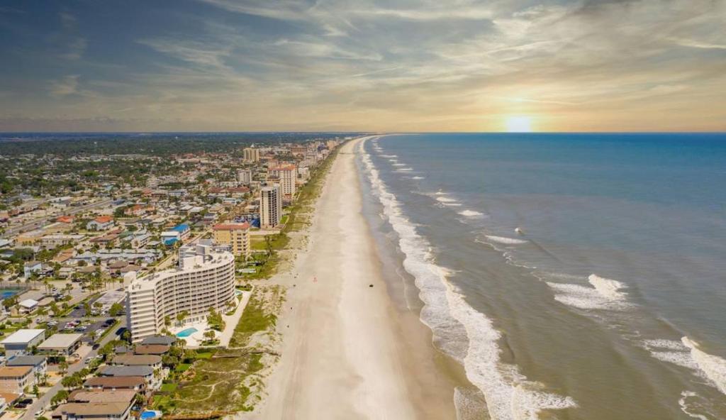 an aerial view of a beach with buildings and the ocean at Coastal Escape Walkable, Cozy Pet-Friendly in Jacksonville Beach