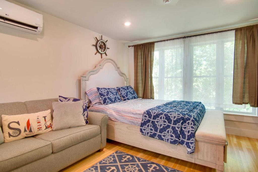 a bedroom with a bed and a couch and a window at Walk to Beach & Lighthouse: Oak Bluffs Studio! in Oak Bluffs