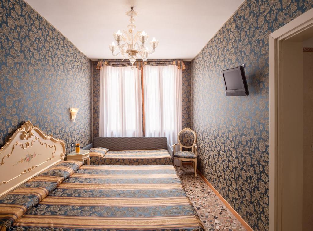 Postel nebo postele na pokoji v ubytování Hotel Il Mercante di Venezia