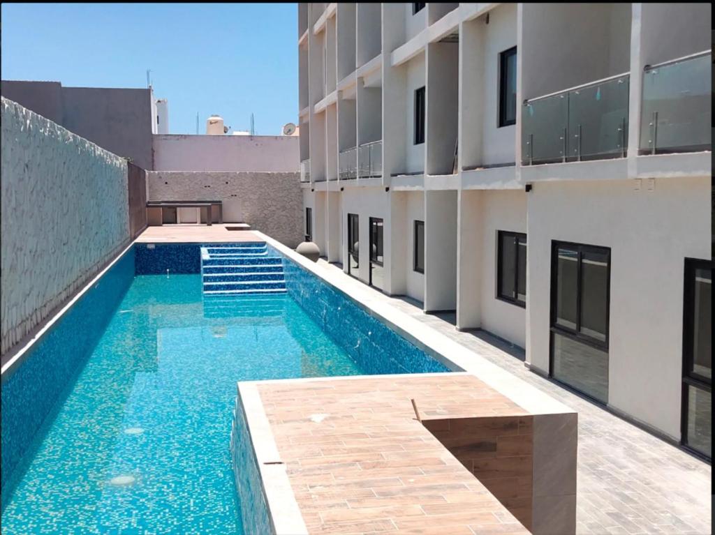 a swimming pool on the side of a building at Spacious family apartment in Mazatlán in Isla Venados