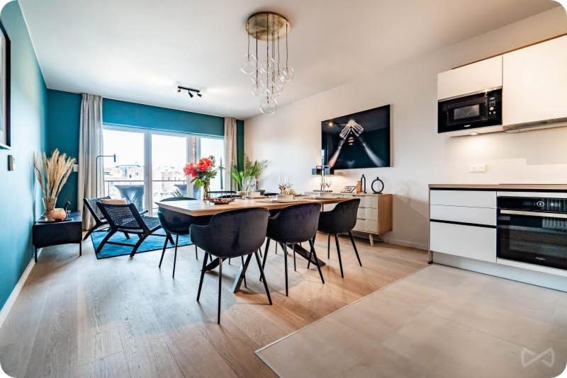 a kitchen and dining room with a table and chairs at Manoir 7ème ciel in Liège