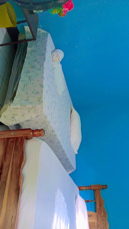 Voodi või voodid majutusasutuse Hostal Isla Natal toas