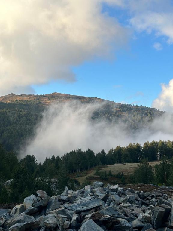 a large pile of rocks in front of a mountain at Aleos cabin in Kolgecaj