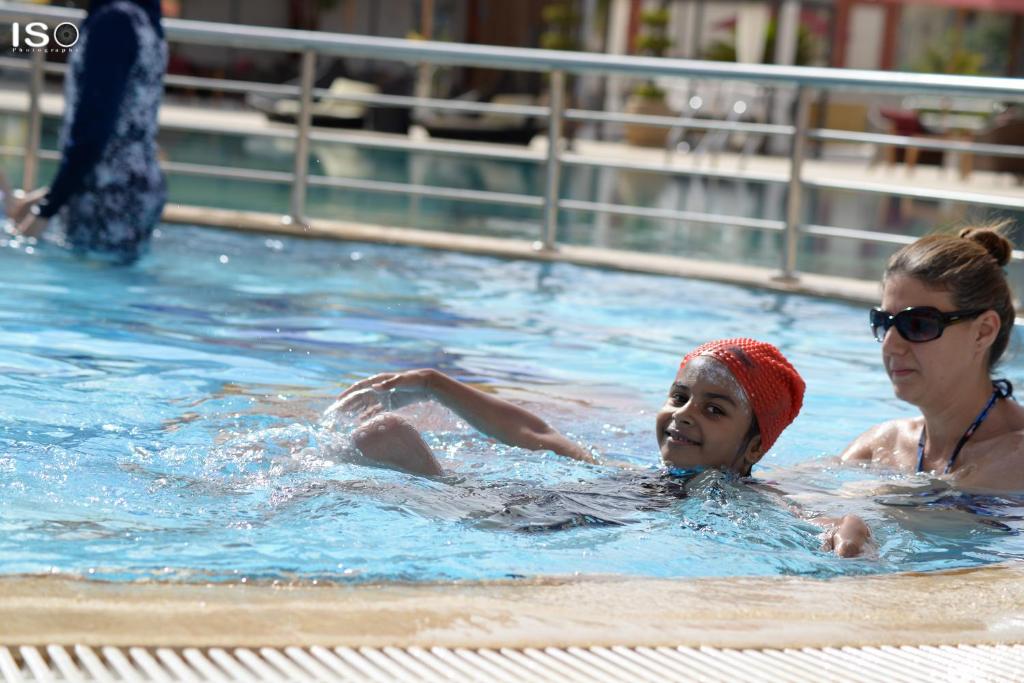 a woman and a child in a swimming pool at Tolip El Narges in Cairo