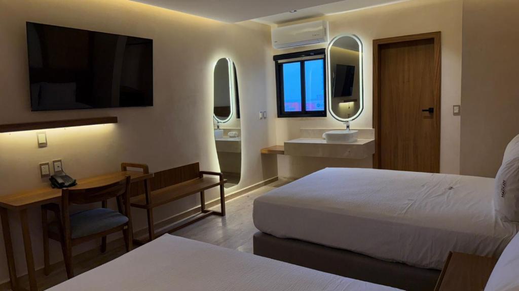 Postel nebo postele na pokoji v ubytování Hotel Makkan Boca