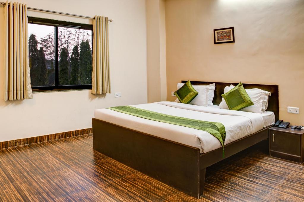 a bedroom with a large bed with a window at The Park Classic Udaipur in Udaipur