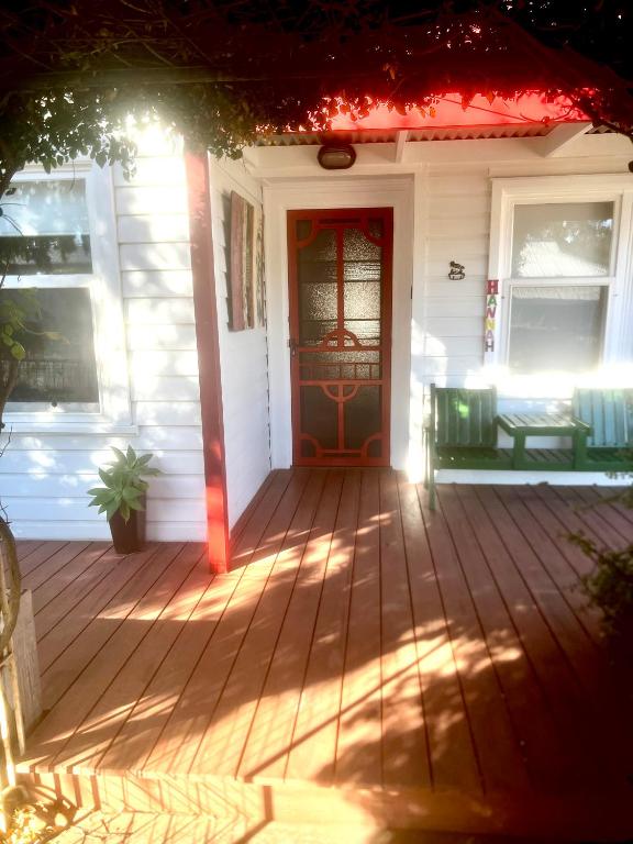 a front door of a white house with a red door at Hill Cottage in Clare