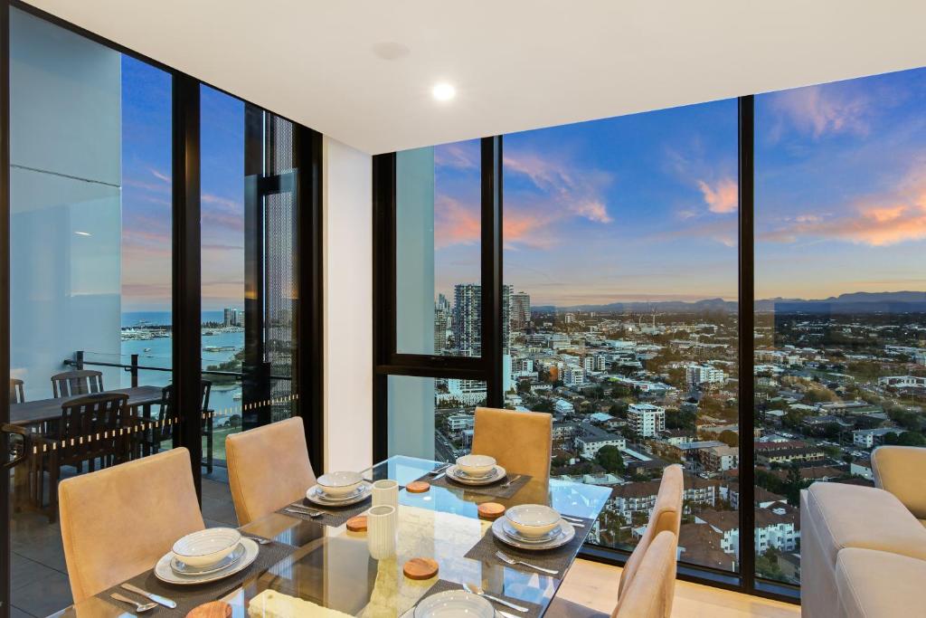 a dining room with a view of the city at Skyline Showdown - Views, Games & Vibes in Gold Coast