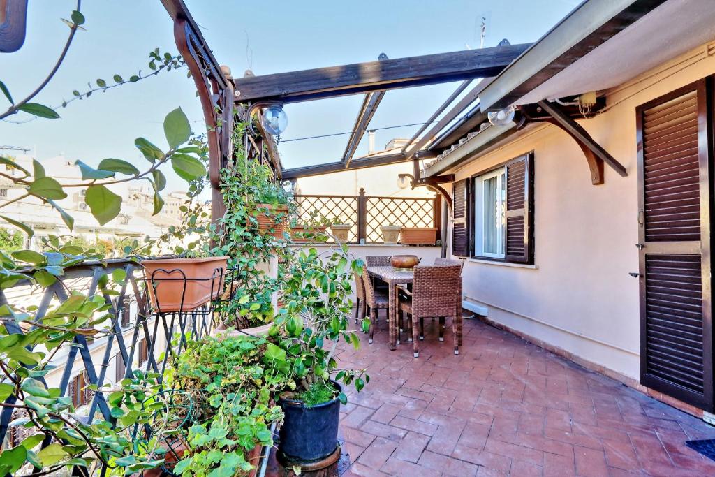 a patio with a table and chairs on a balcony at Frattina Family Romantic Superior Suite in Rome