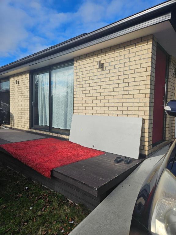 a house with a red carpet on the side of it at Chriatcurrch Best Home in Christchurch