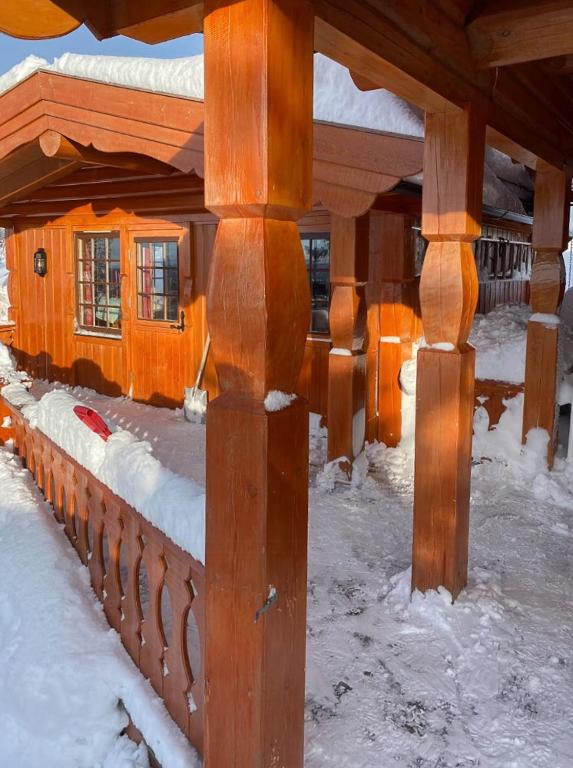a wooden structure in the snow with snow on it at Family Fun Cabin In Engerdals Heart in Nymoen