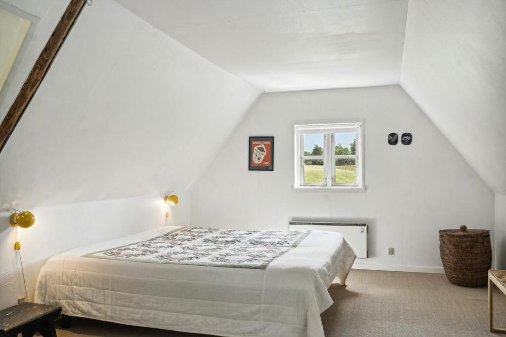 a white bedroom with a bed and a window at 300-Year-Old House With History And Character in Stege
