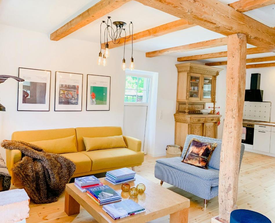 a living room with a yellow couch and a table at Cozy Holiday Home In The Mecklenburg Lake District in Hohen Demzin