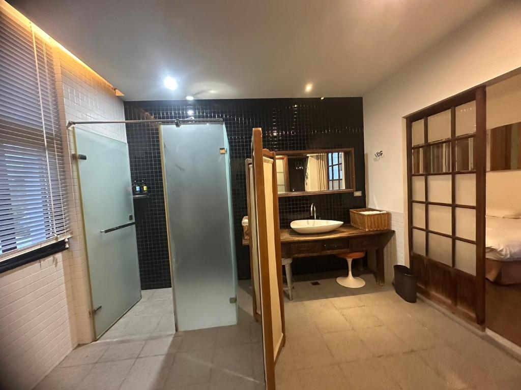 a bathroom with a shower and a sink at Hour Roots in Tainan