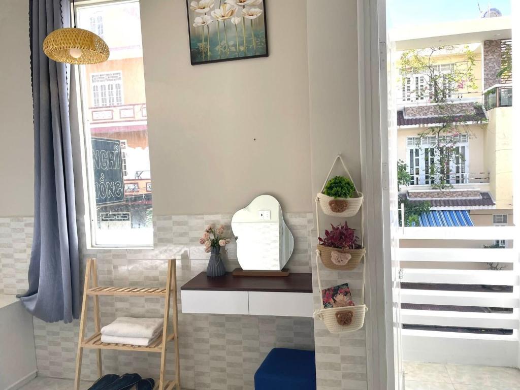 a room with a staircase and a window with plants at Homestay Hoa Hồng in Liên Trì (4)