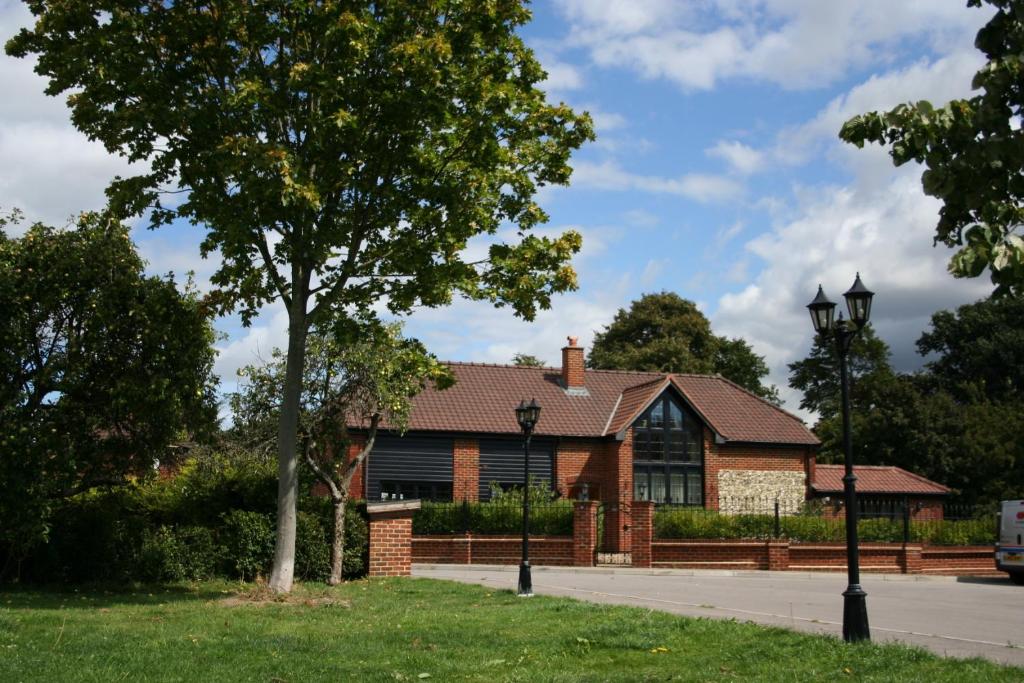 a brick house with a tree in front of it at Millers House Boutique B&B in Emsworth