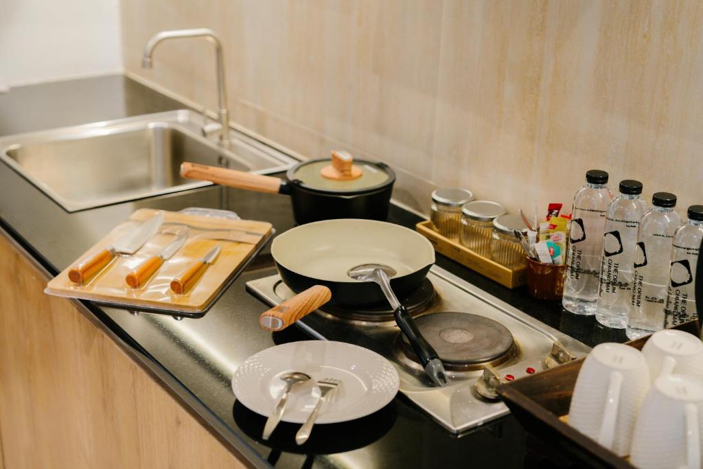 A galley-style kitchenette with a sink, cookware and two-ring hob.