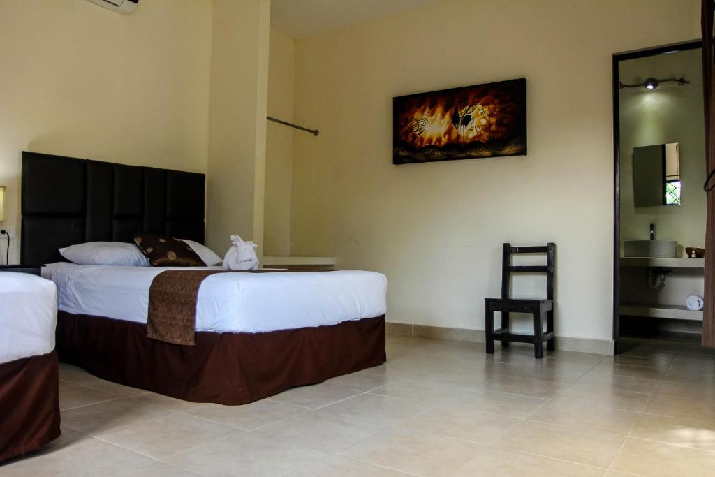 Postel nebo postele na pokoji v ubytování Hotel Hacienda de Izamal
