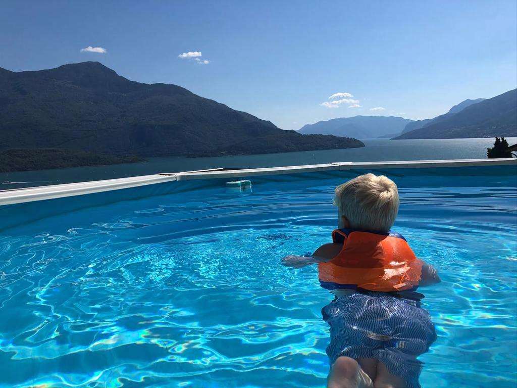 a young boy sitting in a swimming pool at Appartamenti Da Melissa in Vercana