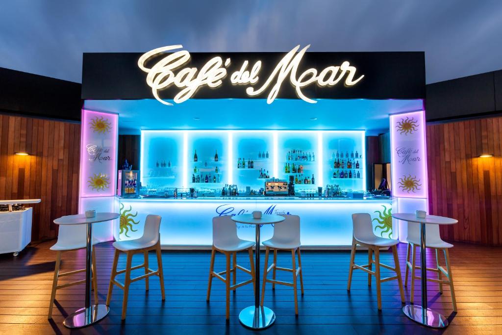 a bar with stools and a sign that reads buy my new at Tigotan Lovers & Friends Playa de las Americas - Adults Only (+18) in Playa de las Americas