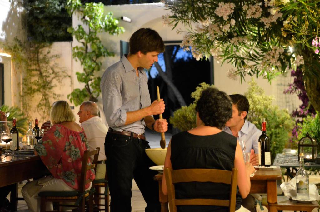 a man standing in a restaurant talking to a group of people at Masseria Il Frantoio in Ostuni