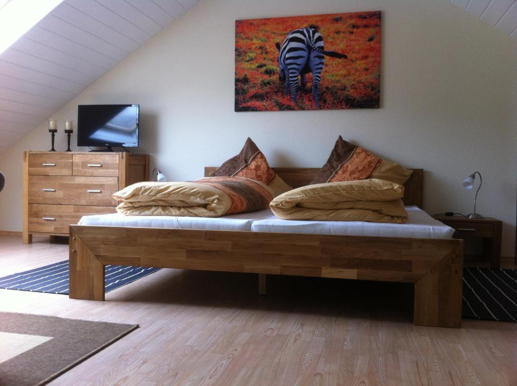 a bed in a room with a zebra painting on the wall at Appartement Kirchenblick in Bad Birnbach