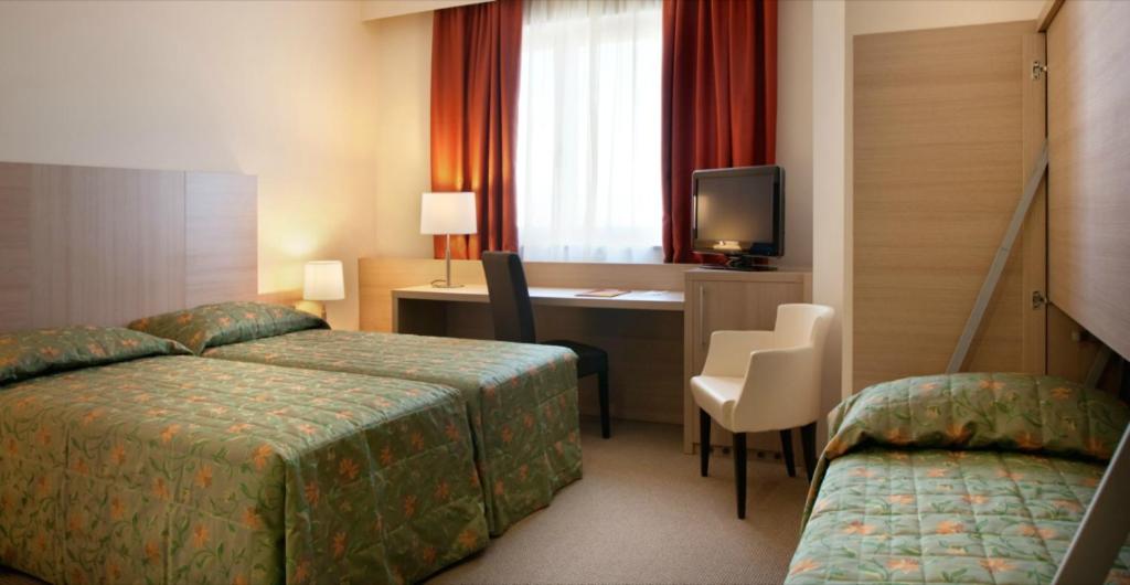 Postel nebo postele na pokoji v ubytování Torino Hotel San Luigi - Ristorante Trait d'Union