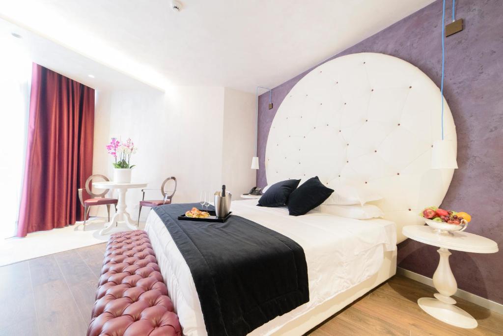 Postel nebo postele na pokoji v ubytování Hotel Vespasiano