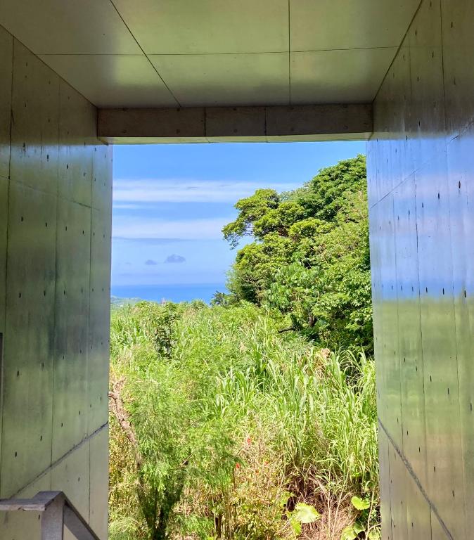 a view of the ocean from the inside of a building at Asahinoyado Shidakaji in Nanjo