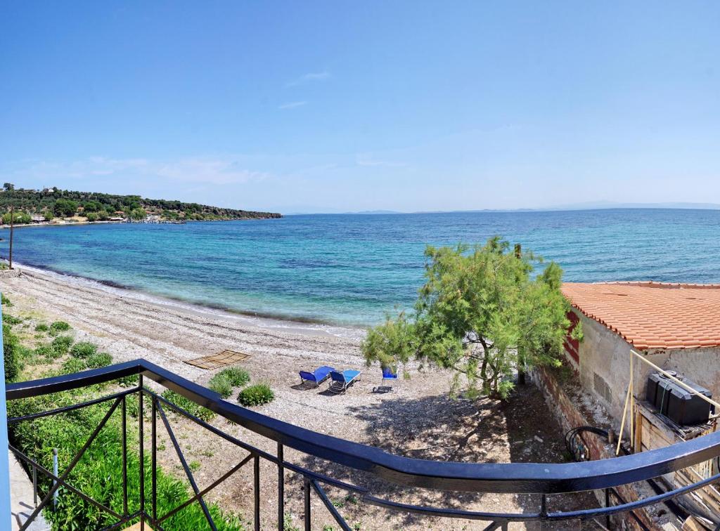 a view of a beach with chairs and the ocean at anatoli by the sea in Skala Mistegnon