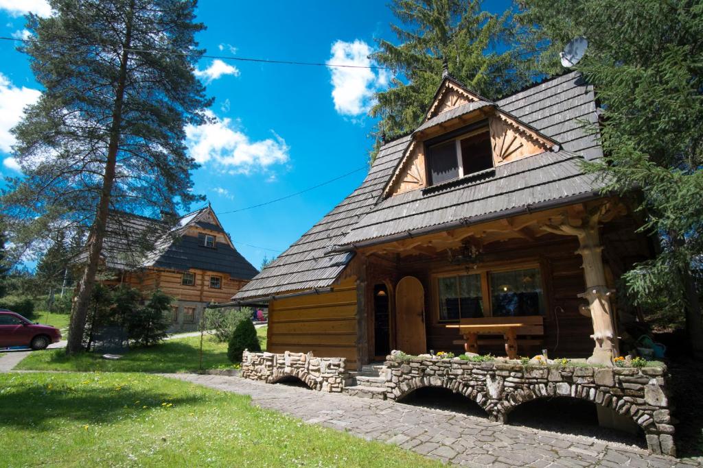 a log cabin with a bridge in front of it at Osada Oleńka Witów in Witów