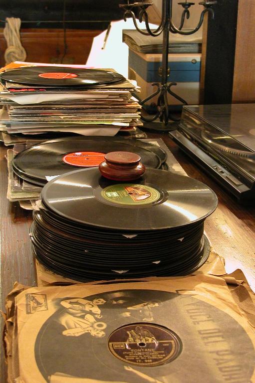 a stack of records sitting on top of a table at Masseria Il Frantoio in Ostuni