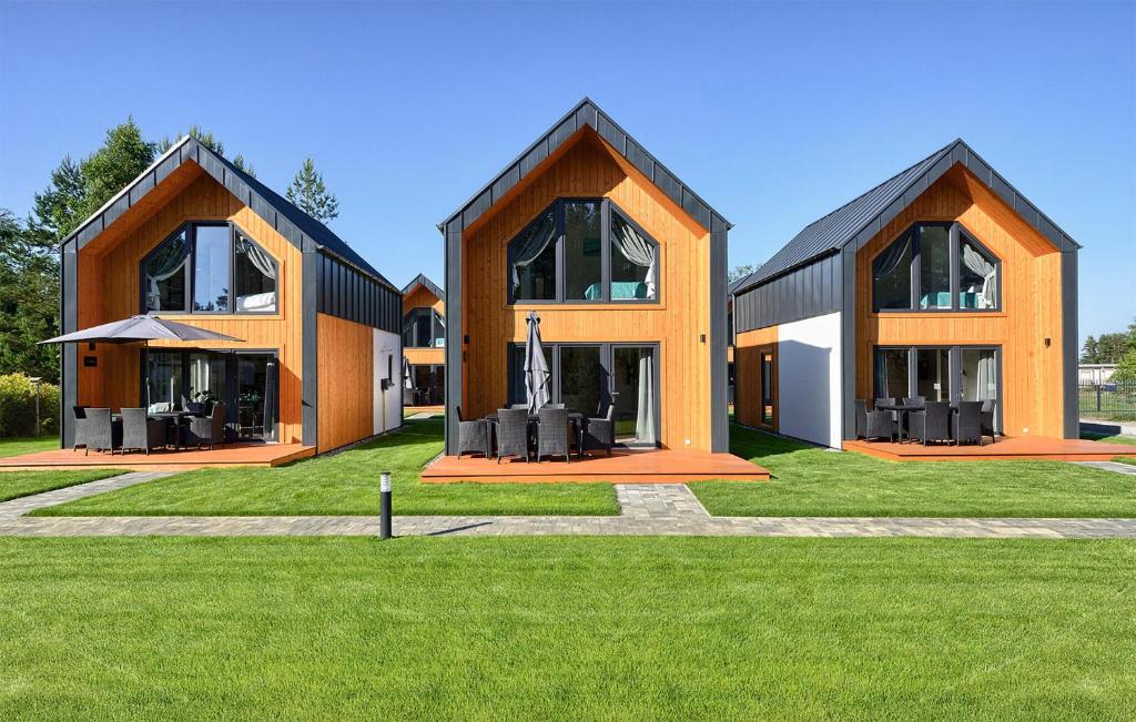 a large building with large windows on a green field at Amazing Home In Bialogora With Wifi in Białogóra