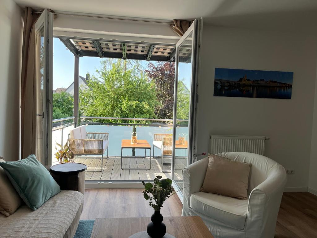 a living room with a couch and a sliding glass door at Casa Sophia - stadtnahe, großzügige Ferienwohnung in Regensburg