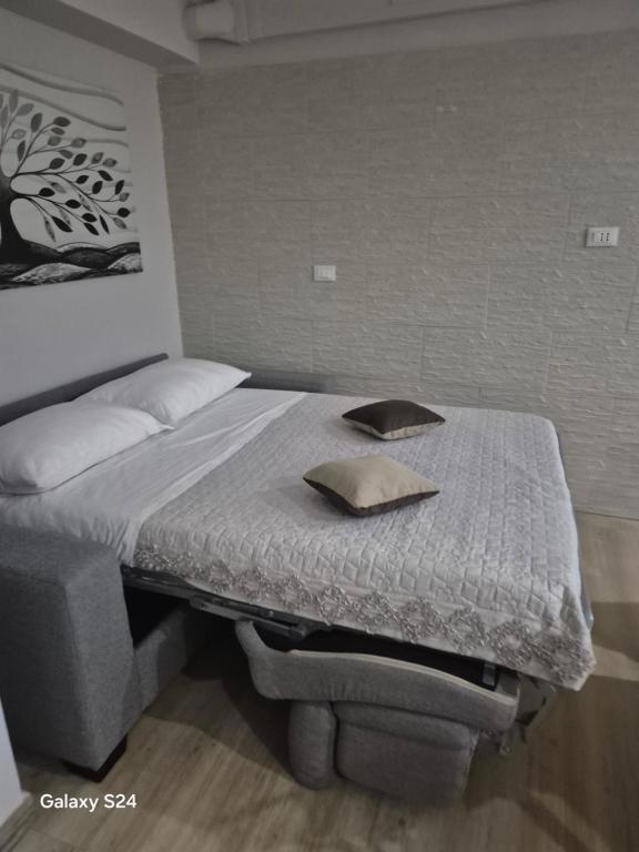 a bed with two pillows on it in a bedroom at Sweet Home Sofia in Barletta