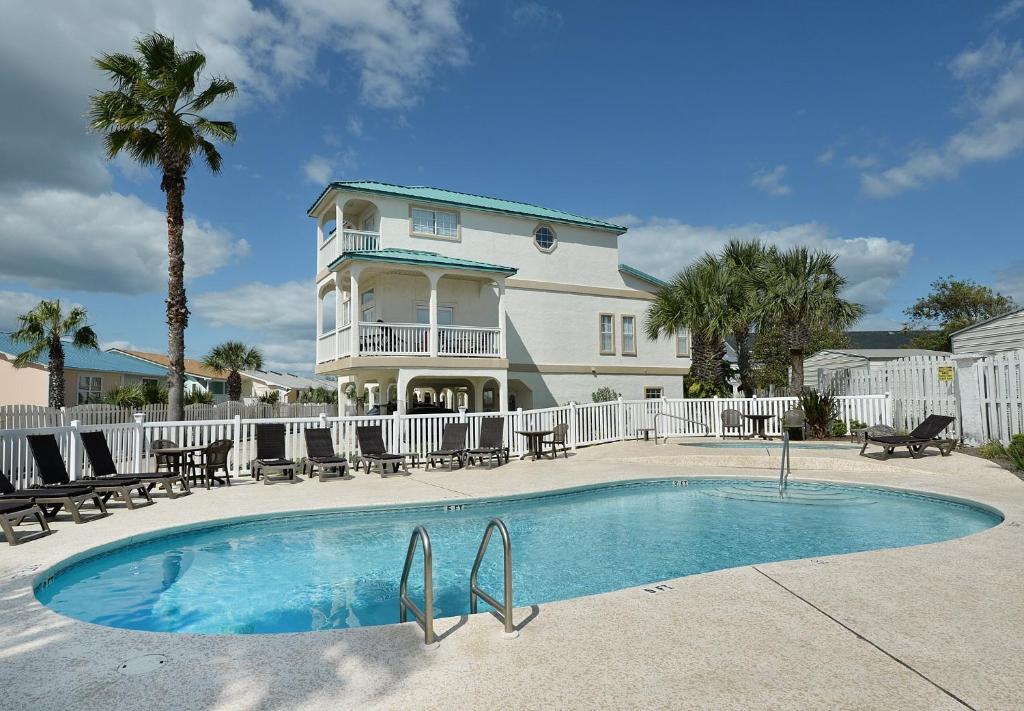 a house with a swimming pool in front of a house at Tranquil Beach & Hot Tub & Pool Getaway in Panama City Beach