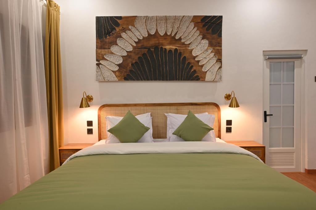 Postel nebo postele na pokoji v ubytování Huma Yogyakarta Hostel