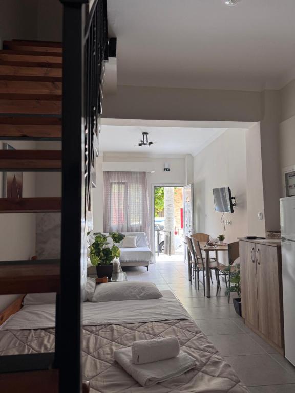 a kitchen and a living room with a bed in a room at Mariam Apartment in Nea Moudania