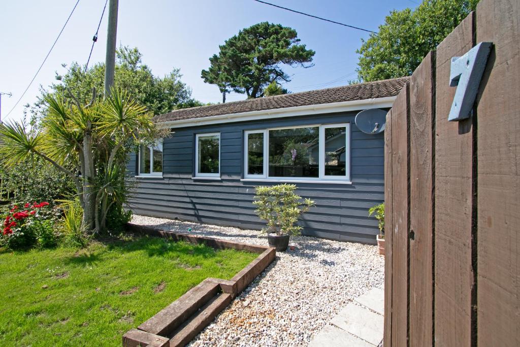 a blue house with a garden in front of it at 7 Porth Valley Cottage's in Newquay