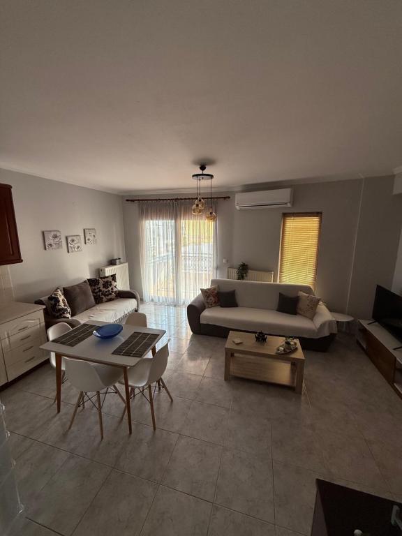 a living room with a couch and a table at Proluxe Apartments in Alexandroupoli