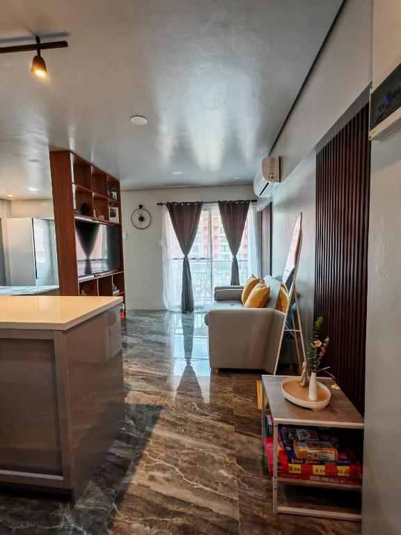 a living room with a couch and a table at Traveler's Nest near Airport, Netflix, Stylish, Cozy with swimming pool in Lapu Lapu City