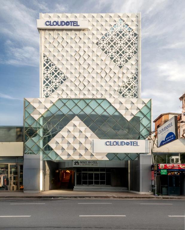 a building with a geometric facade on a street at Cloudotel Walking Street Pattaya in Pattaya