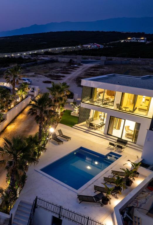 an aerial view of a house with a swimming pool at Villa London in Novalja