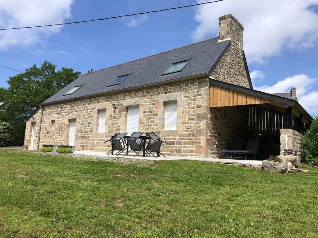 a brick building with two sculptures in front of it at Maison Albert 