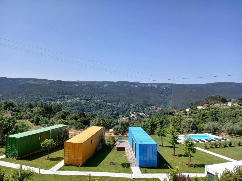a view of two buildings and a swimming pool at Vizinhos do Sol Turismo Rural in Valadares